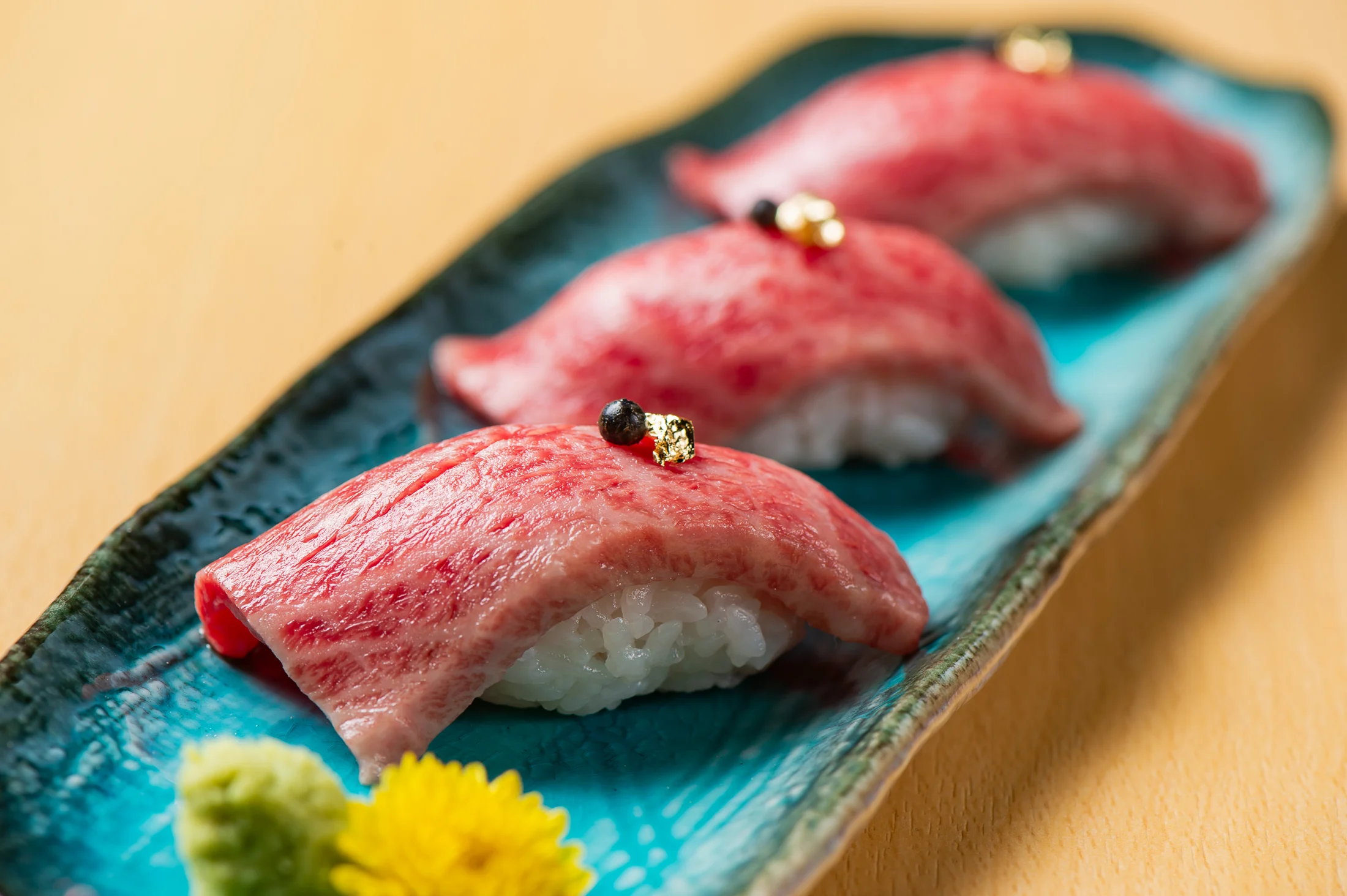 Beef sushi on a blue plate